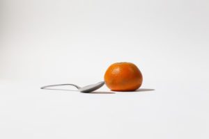 metal spoon and an orange