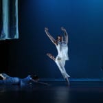 male dancer leaps among curtains