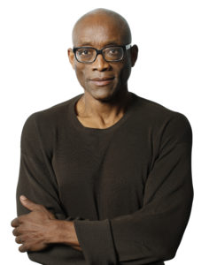 jones in glasses arms crossed in black shirt