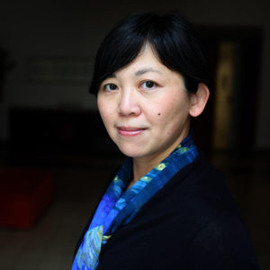 yiyun li with short dark hair and bright blue patterned scarf