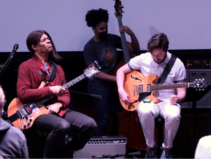 Stanley Jordan plays guitar with other musicians on stage