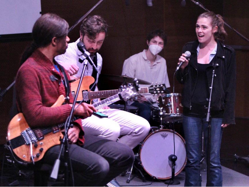 Stanley Jordan plays guitar with other musicians on stage