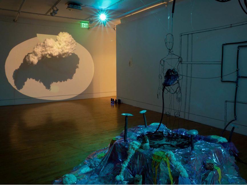 Artwork in a studio featuring a hanging cloud lit by dramatic lighting