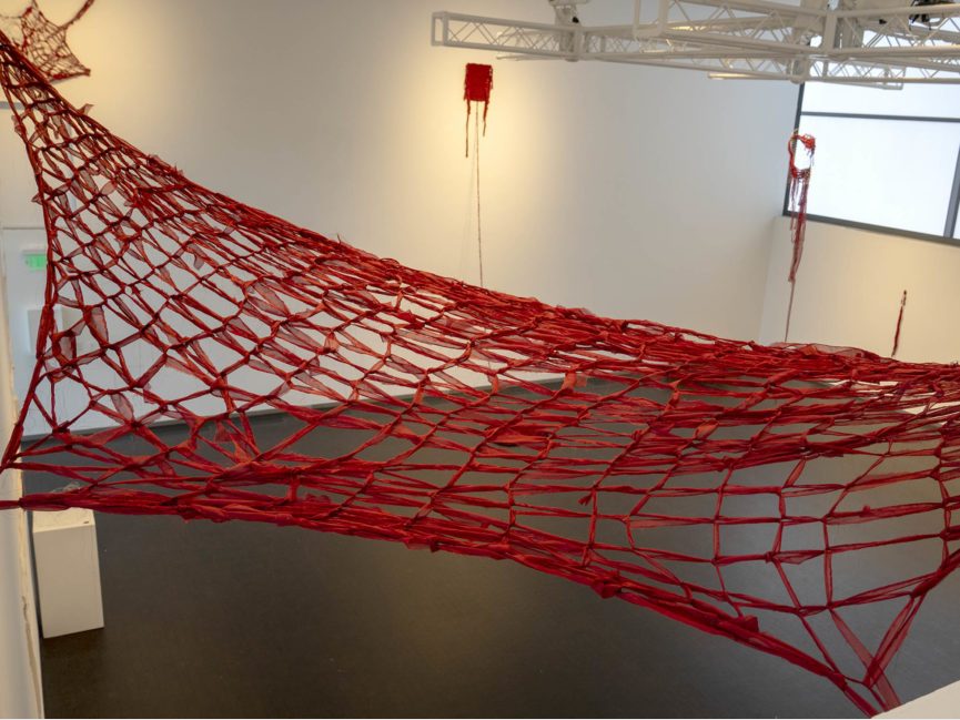 red net stretches across gallery space