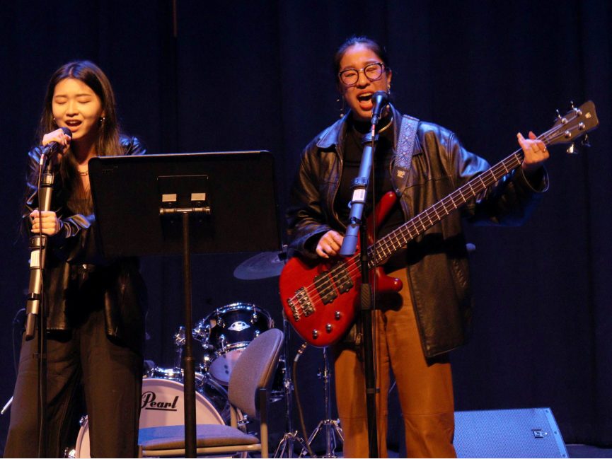 A singer and a bass player perform