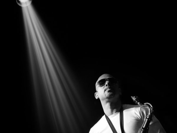 saxophone player in spotlight on stage