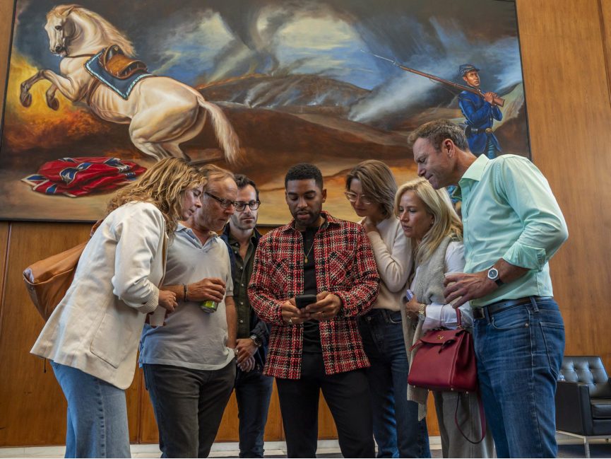 Mario Moore speaks to a group in front of his painting The Great Reckoning