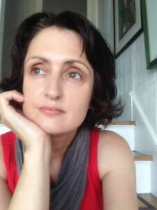 mary burke looks off to the side, resting her chin in her right hand.