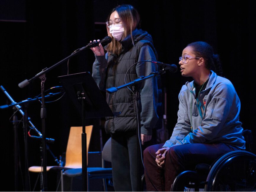 Two people perform on stage