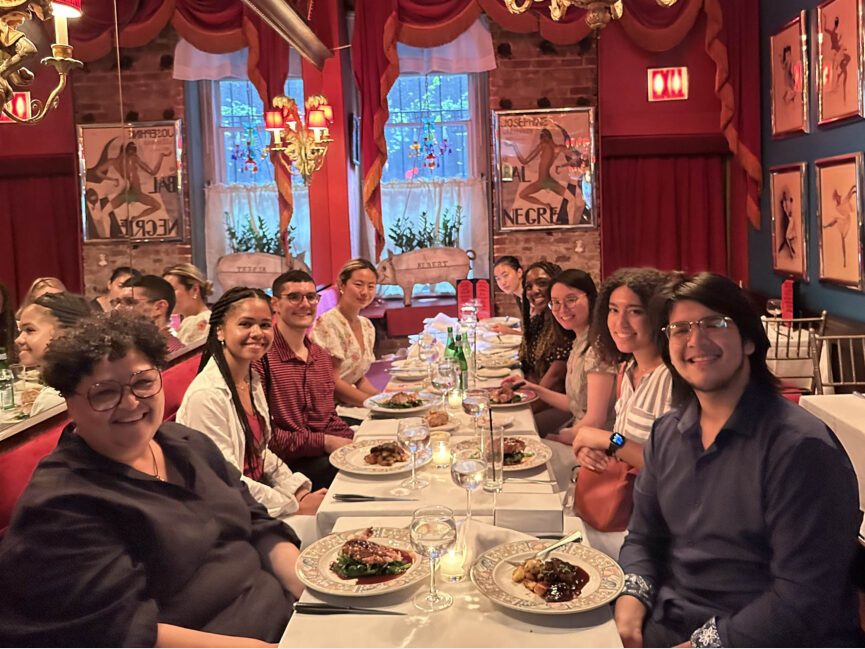 Students pose for a picture at a dinner table