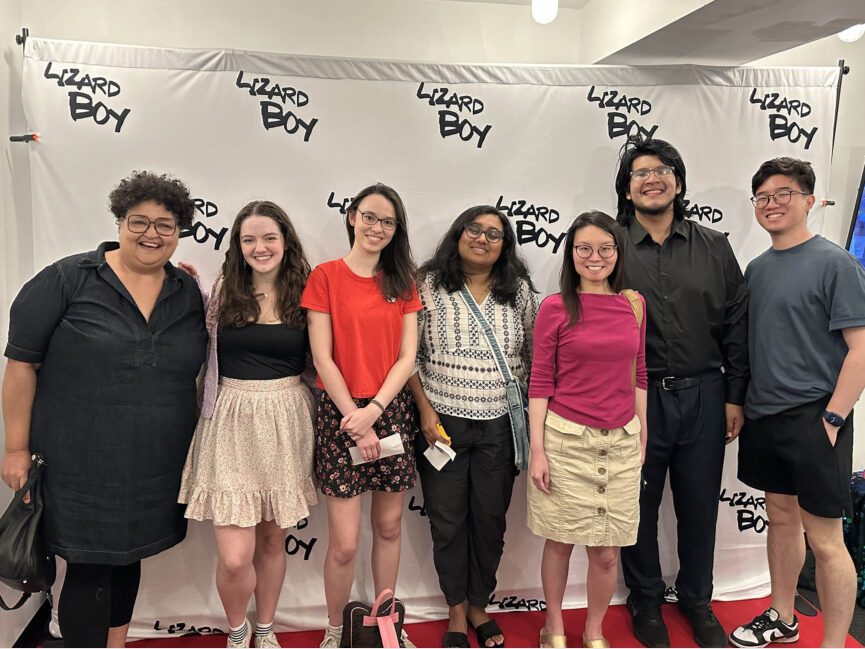 People stand in a line and pose for a photo.