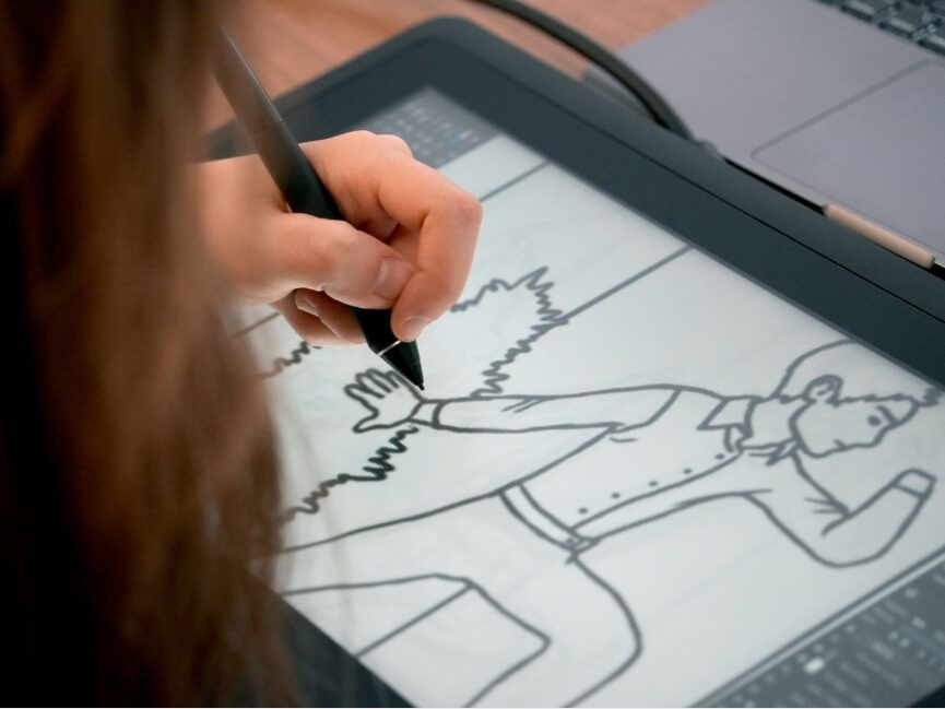 A student works on an illustration on their digital tablet