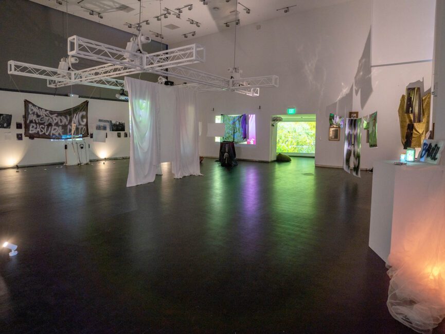 A large gallery space is full of artwork projected and displayed on walls