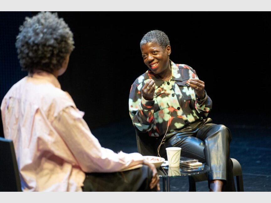 Thelma Golden and Helga Davis (seen from behind) sit and talk.