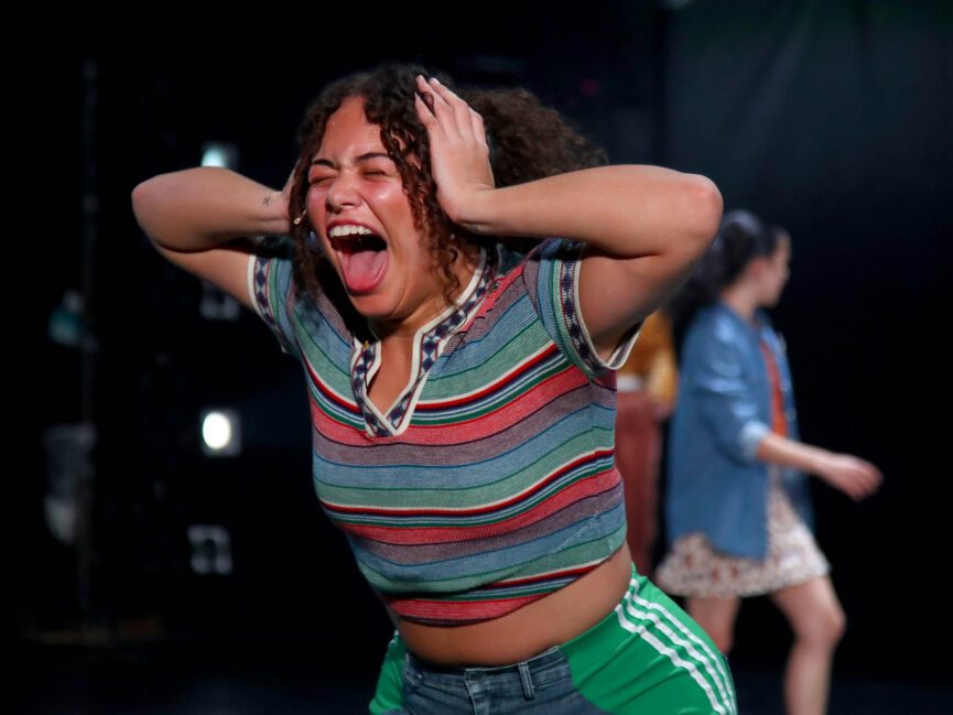 Person in a striped shirt expresses emotion