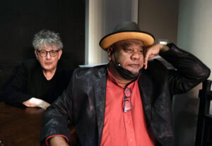 Muldoon and Stew watch action happening off screen.